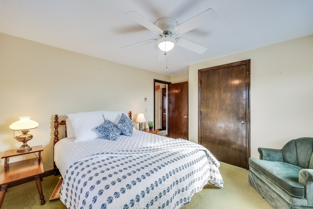 275 Phillips Road Sandwich, MA 02563 - Photo 23 of 40 a bedroom with a bed and ceiling fan