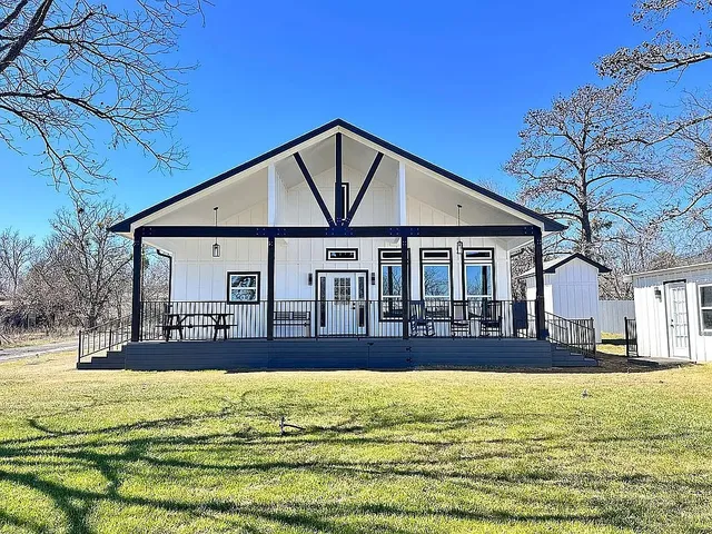 a house view with swimming pool in front of it