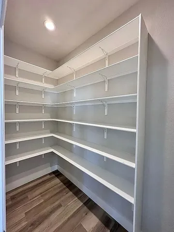 a view of storage and utility room with wooden floor