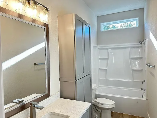 a bathroom with a shower and a toilet