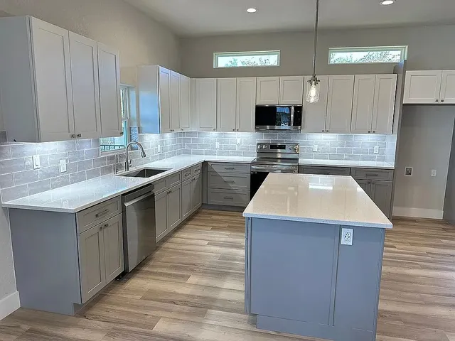 a view of a kitchen with a sink and microwave