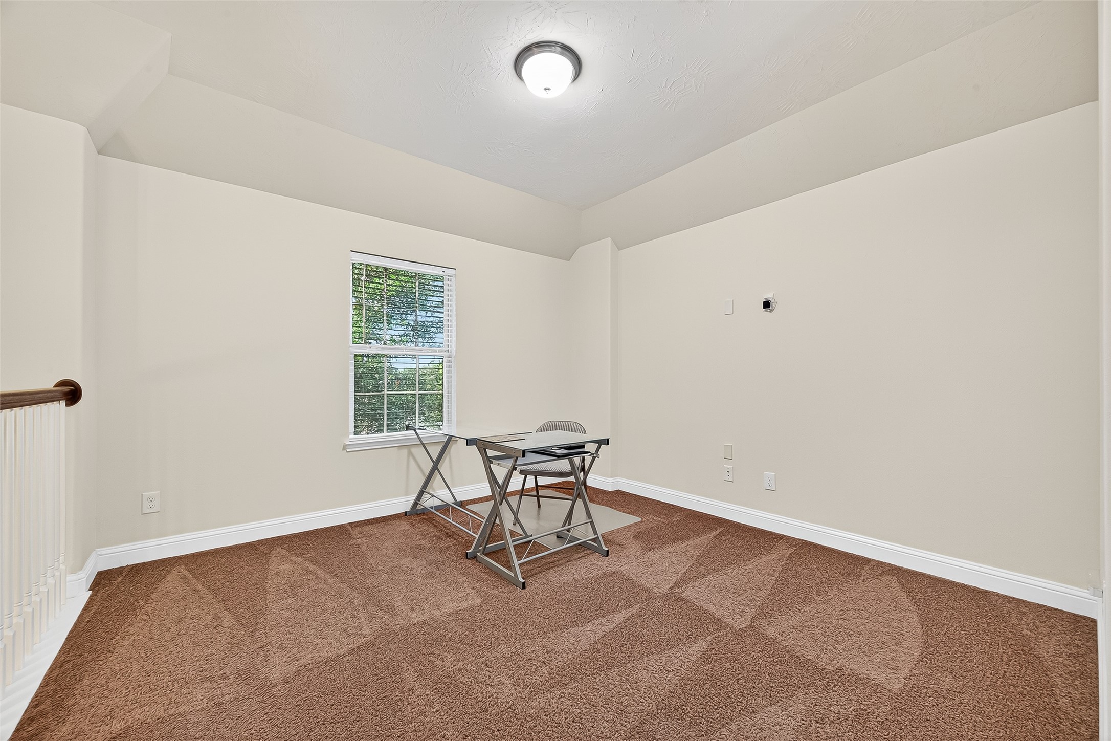 8107 Lockridge Terrace Lane Cypress, TX 77433 - Photo 36 of 50 Versatile upstairs game room with plush carpet and natural light—perfect for movie nights, playtime, or a quiet home office. This flexible space adapts to your lifestyle and adds a cozy retreat to your daily living.