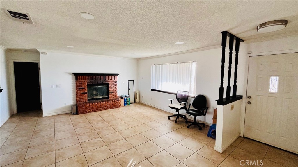 11911 Kiowa Road Apple Valley, CA 92308 - Photo 17 of 40 a view of a livingroom with workspace and a window