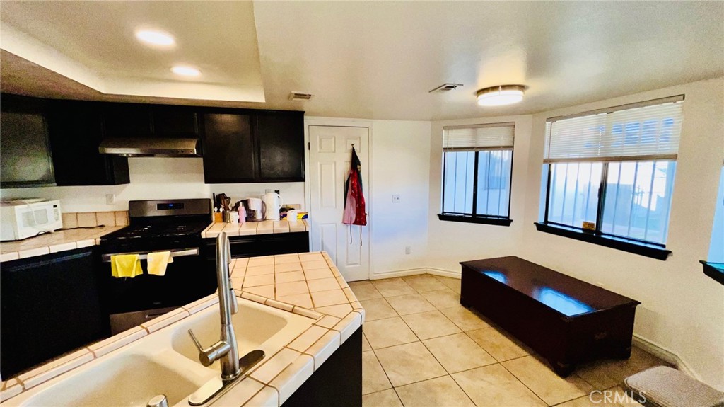 11911 Kiowa Road Apple Valley, CA 92308 - Photo 20 of 40 a living room with stainless steel appliances furniture and a flat screen tv