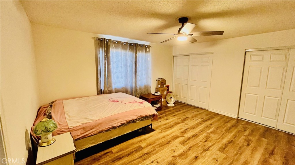 11911 Kiowa Road Apple Valley, CA 92308 - Photo 22 of 40 a bedroom with a bed and cabinets