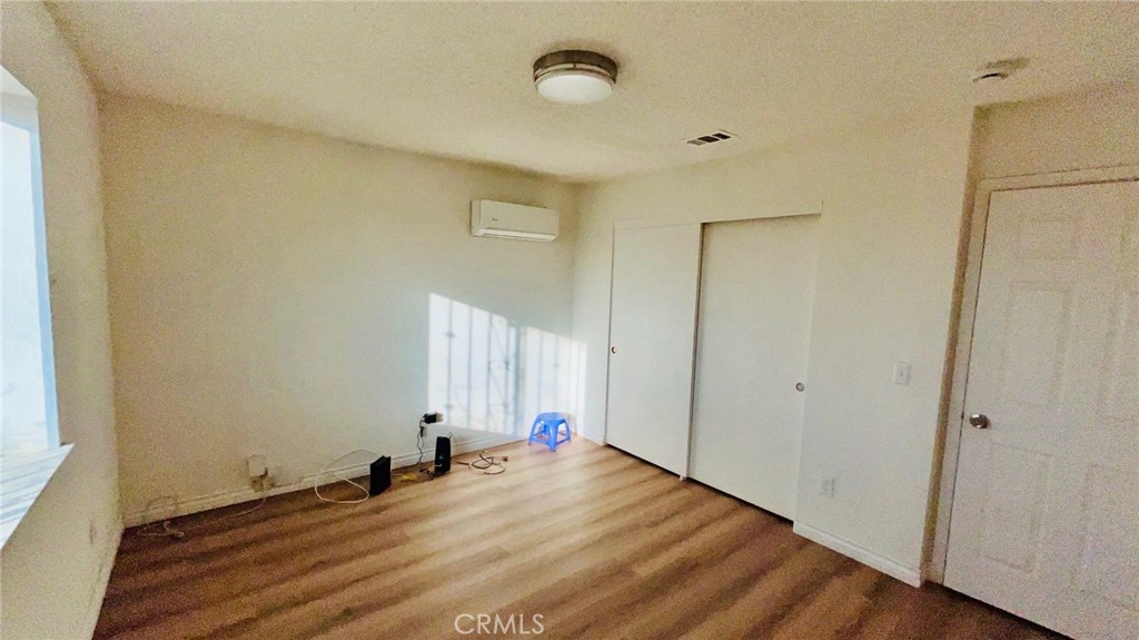 11911 Kiowa Road Apple Valley, CA 92308 - Photo 25 of 40 a view of a room with wooden floor and window