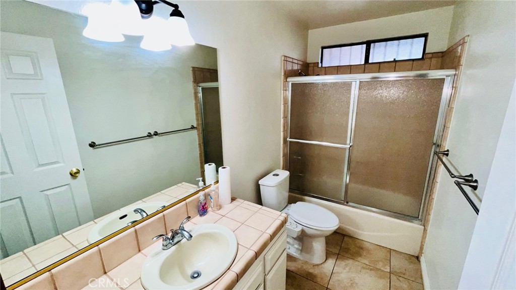 11911 Kiowa Road Apple Valley, CA 92308 - Photo 26 of 40 a bathroom with a sink toilet and shower