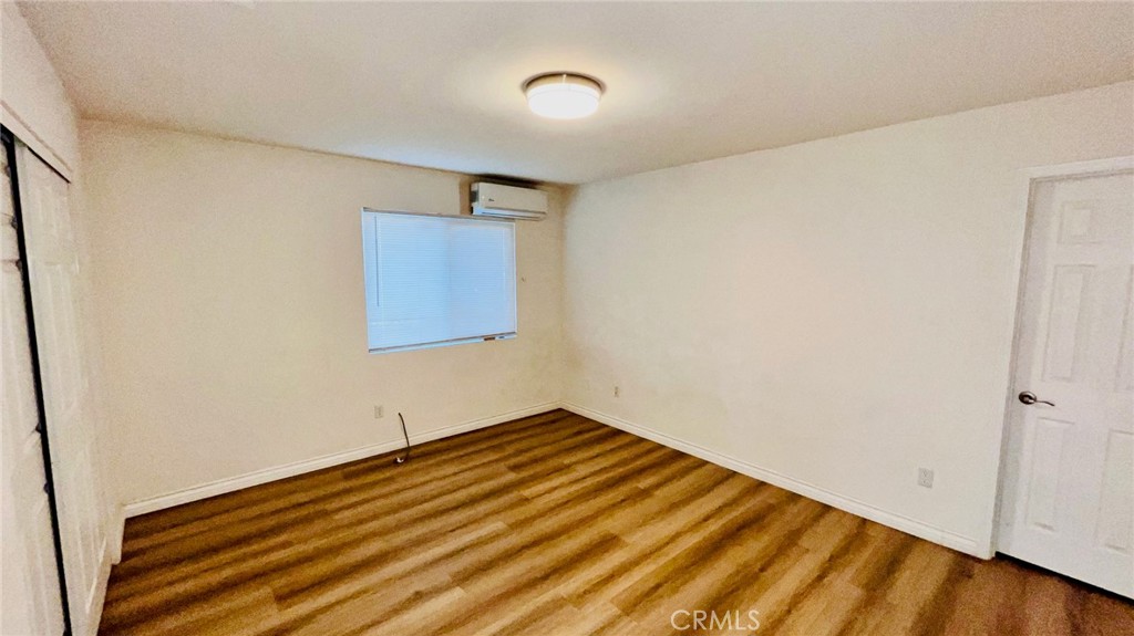 11911 Kiowa Road Apple Valley, CA 92308 - Photo 27 of 40 a view of a room with wooden floor and white walls