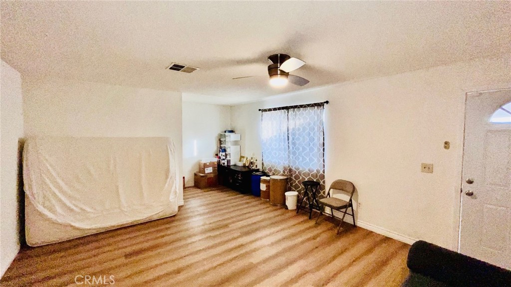 11911 Kiowa Road Apple Valley, CA 92308 - Photo 30 of 40 a view of a room with wooden floor and furniture
