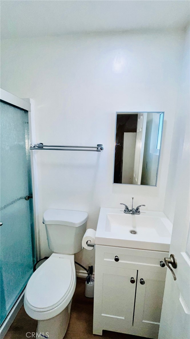 11911 Kiowa Road Apple Valley, CA 92308 - Photo 31 of 40 a white toilet sitting next to a bathroom sink