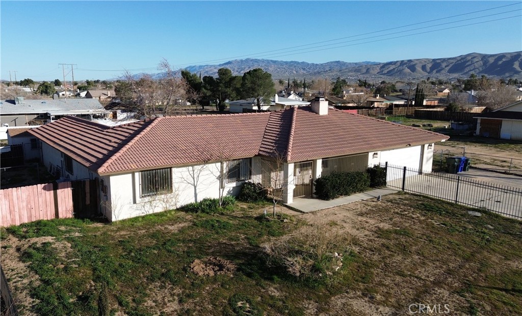 11911 Kiowa Road Apple Valley, CA 92308 - Photo 4 of 40 a view of a house with a yard and mountain view