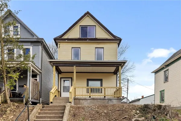 a front view of a house with a yard