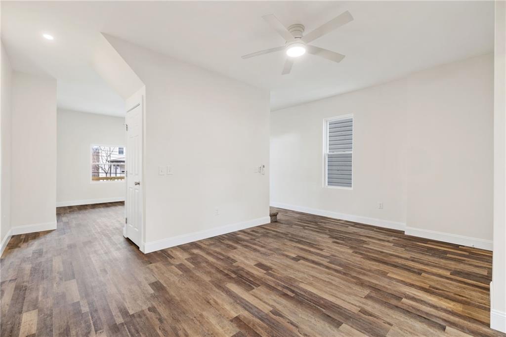 311 Elsdon Street Pittsburgh, PA 15214 - Photo 11 of 35 an empty room with wooden floor chandelier fan and windows