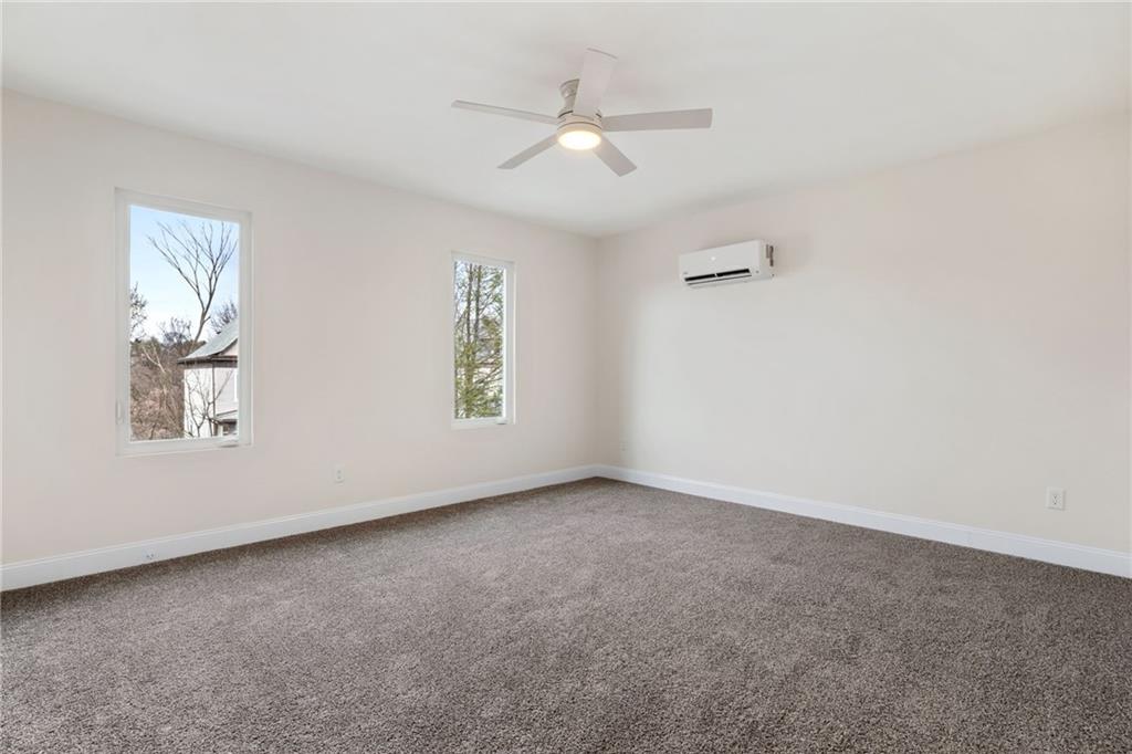 311 Elsdon Street Pittsburgh, PA 15214 - Photo 16 of 35 an empty room with windows and ceiling fan