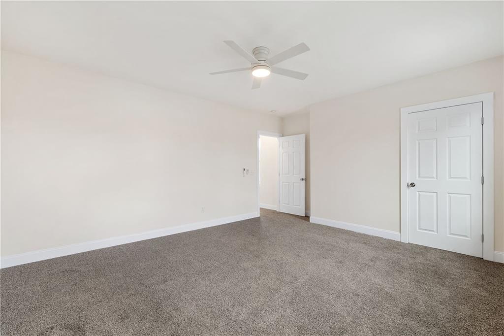 311 Elsdon Street Pittsburgh, PA 15214 - Photo 17 of 35 an empty room with a ceiling fan and a window