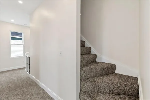 a living room with furniture and a hallway