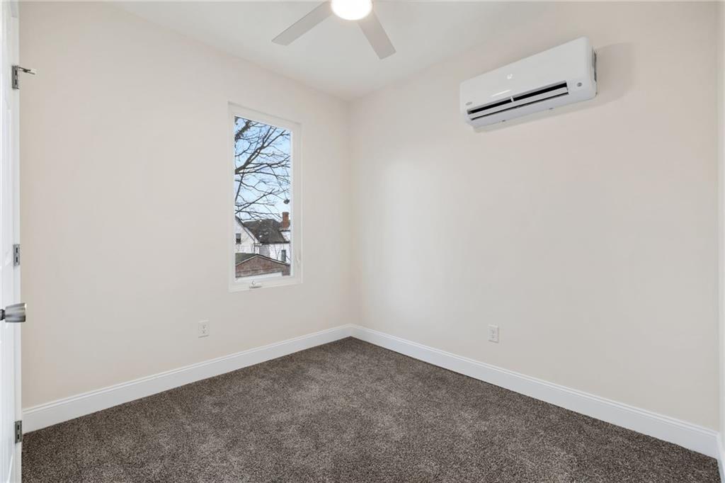 311 Elsdon Street Pittsburgh, PA 15214 - Photo 19 of 35 an empty room with a window and a ceiling fan