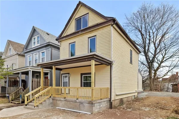 a front view of a house with a yard