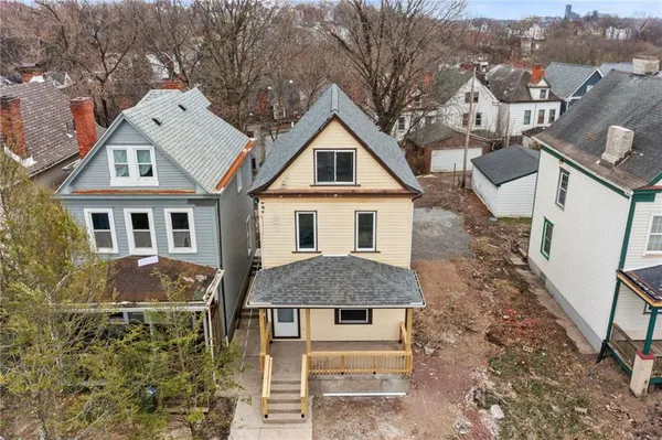 a aerial view of a house with a yard