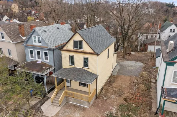 a aerial view of a house with a yard and balcony