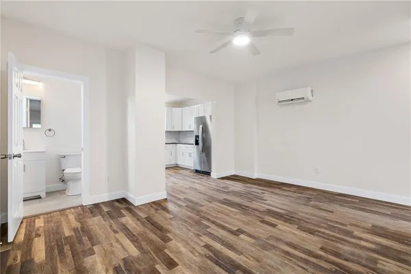 a view of empty room with wooden floor