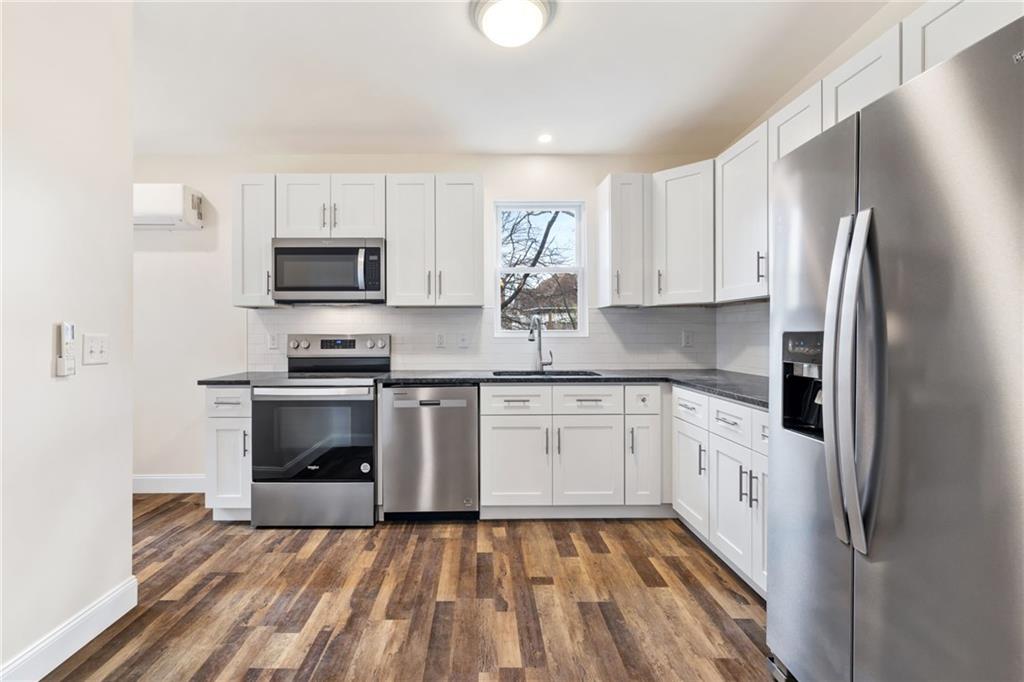 311 Elsdon Street Pittsburgh, PA 15214 - Photo 5 of 35 a kitchen with stainless steel appliances a refrigerator sink and microwave