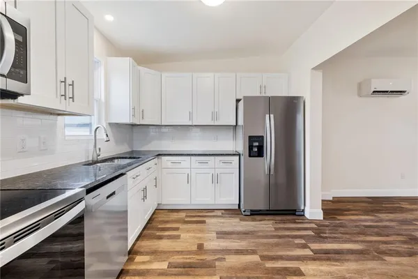 a kitchen with stainless steel appliances granite countertop a refrigerator sink and cabinets