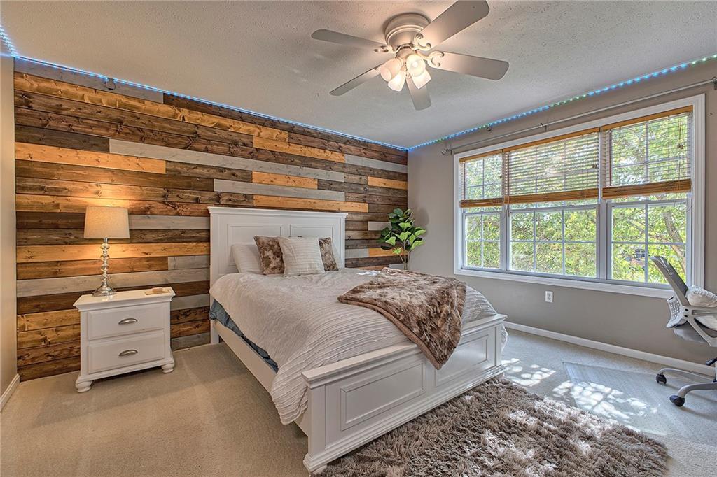 142 Lentz Road Latrobe, PA 15650 - Photo 22 of 32 a bedroom with a large bed and a chandelier