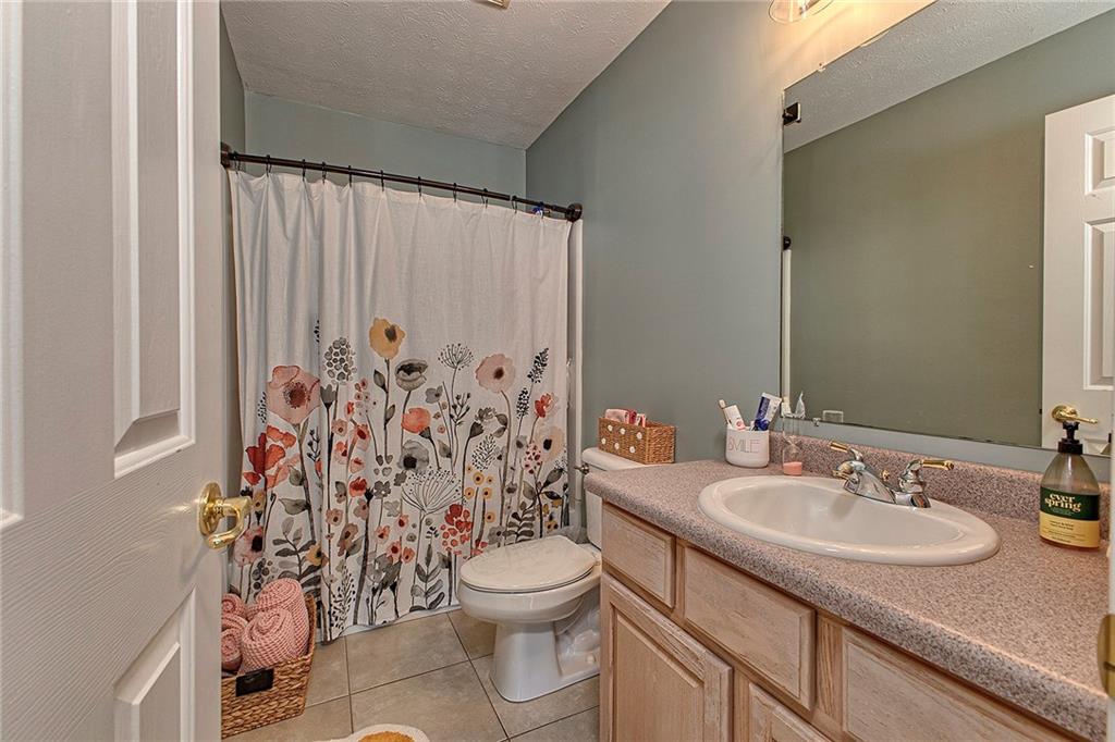 142 Lentz Road Latrobe, PA 15650 - Photo 26 of 32 a bathroom with a granite countertop sink toilet and shower