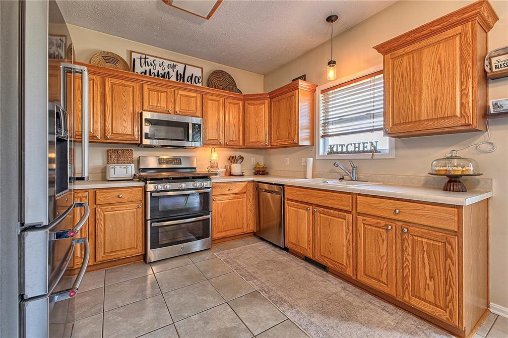 142 Lentz Road Latrobe, PA 15650 - Photo 7 of 32 a kitchen with stainless steel appliances granite countertop a refrigerator and a stove top oven