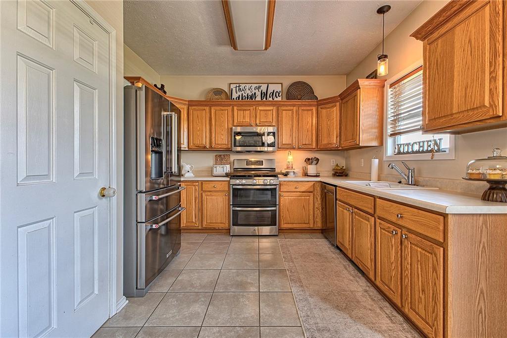 142 Lentz Road Latrobe, PA 15650 - Photo 8 of 32 a kitchen with stainless steel appliances granite countertop a refrigerator and a sink