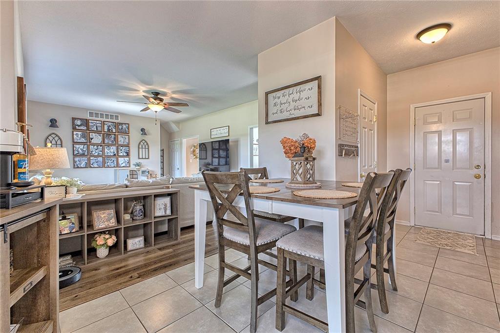 142 Lentz Road Latrobe, PA 15650 - Photo 9 of 32 a view of a dining room and livingroom with furniture a rug a painting and a chandelier