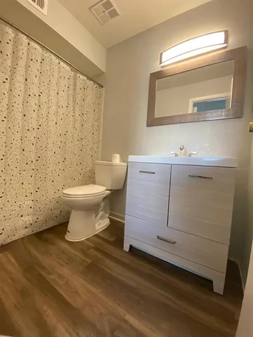 a bathroom with a sink a toilet and mirror