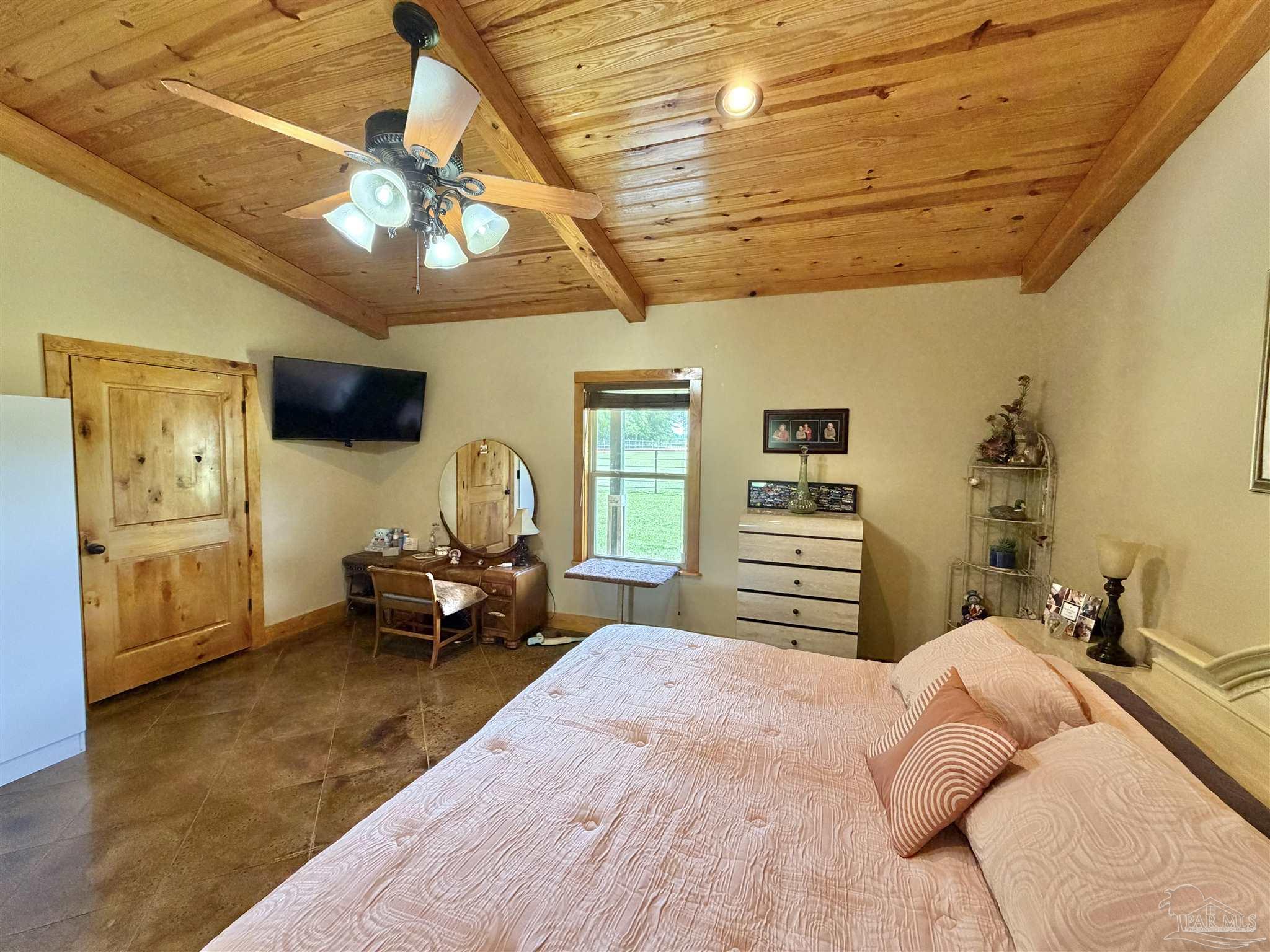 145 Tower Road Uriah, AL 36480 - Photo 13 of 72 a bedroom with a large bed and a chandelier