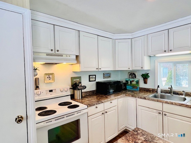 19 Old Forge Road Westbrook, CT 06498 - Photo 3 of 16 a kitchen with granite countertop white cabinets and white appliances