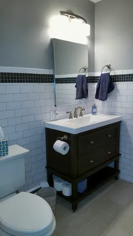 a kitchen with a checkered floor and white cabinets a black and white checkered floor