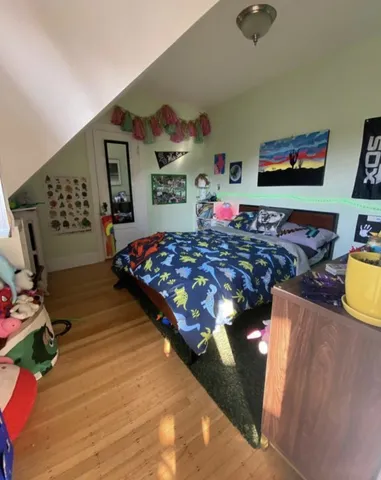 a bedroom with furniture and a large window