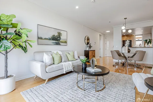 a living room with furniture and a potted plant