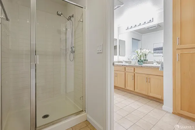 a bathroom with a shower sink and mirror