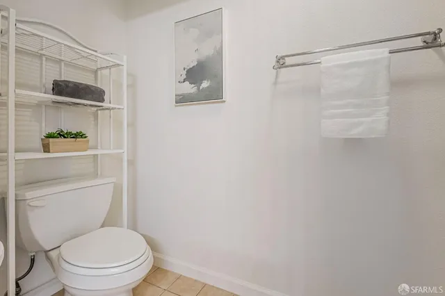 a white toilet sitting next to a shower