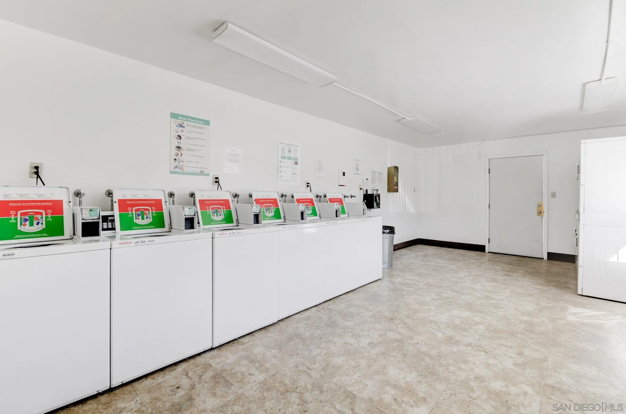 6775 Alvarado Road, Unit 21 San Diego, CA 92120 - Photo 26 of 27 a white kitchen with refrigerator and white cabinets