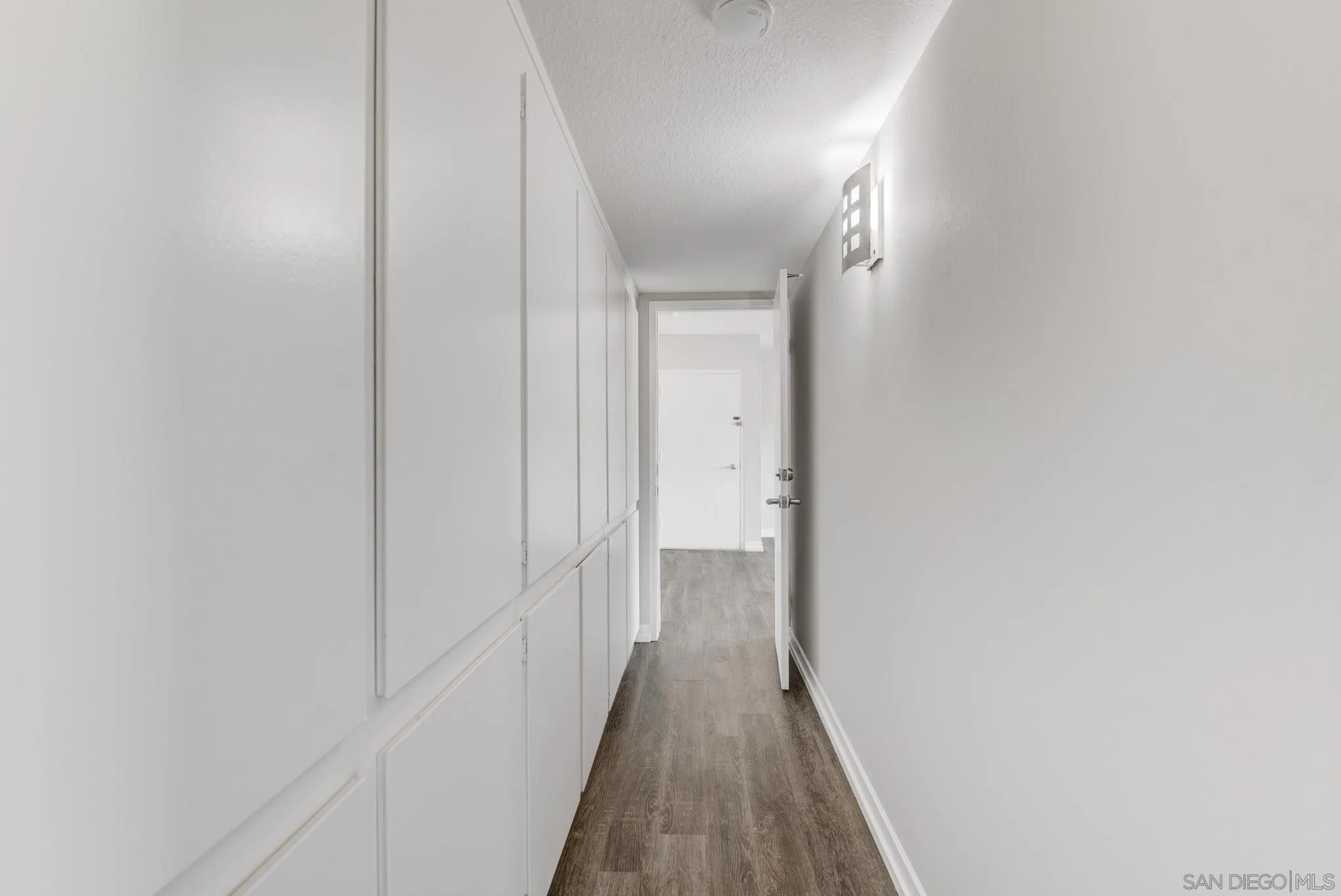 6775 Alvarado Road, Unit 21 San Diego, CA 92120 - Photo 8 of 27 a view of a hallway with wooden floor