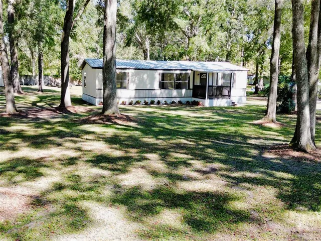 a view of a house with a yard patio and swimming pool