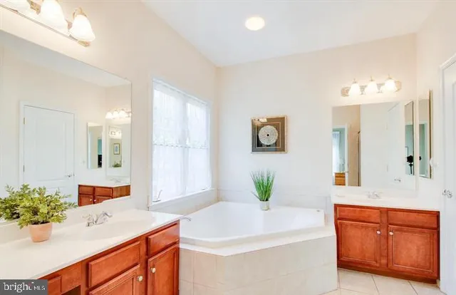 a bathroom with a sink double vanity and mirror