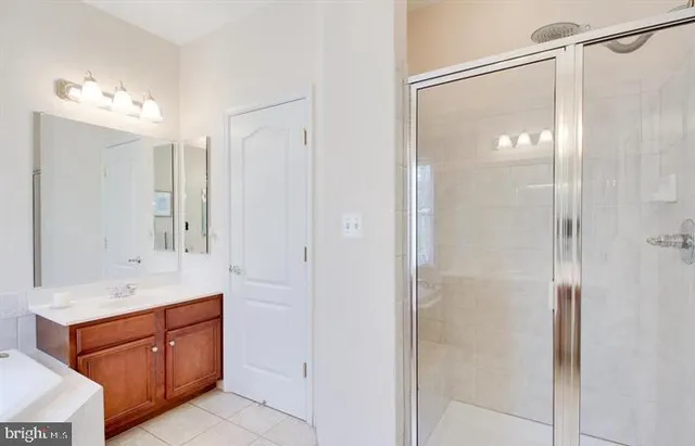 a bathroom with a double vanity sink mirror and shower