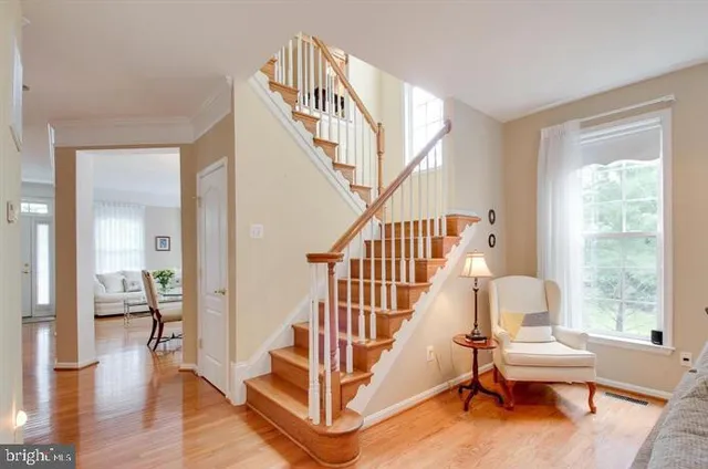 a view of entryway livingroom and hall with wooden floor