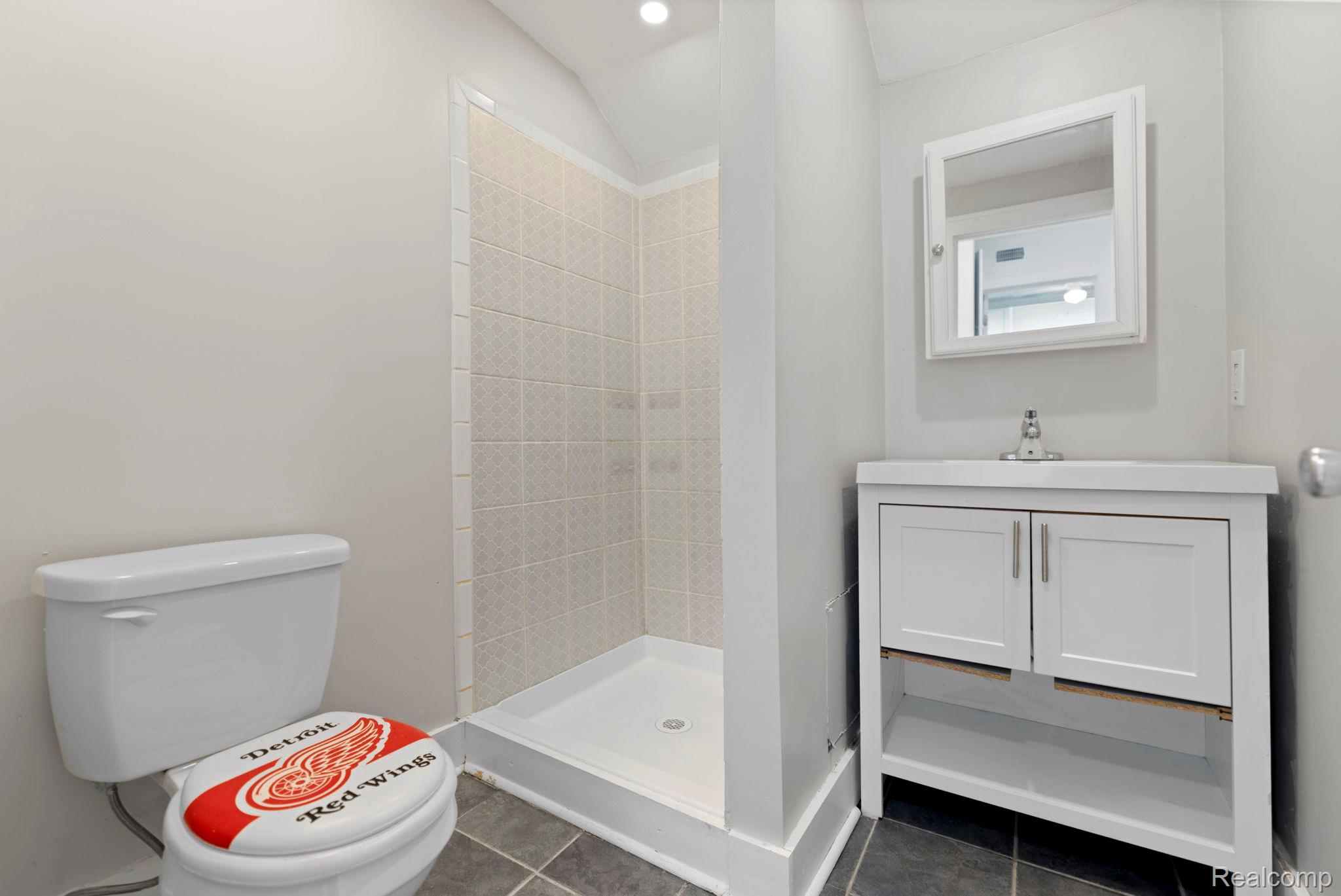 74 Pine Street River Rouge, MI 48218 - Photo 10 of 28 Bathroom with vanity, a stall shower, dark tile patterned flooring, and recessed lighting