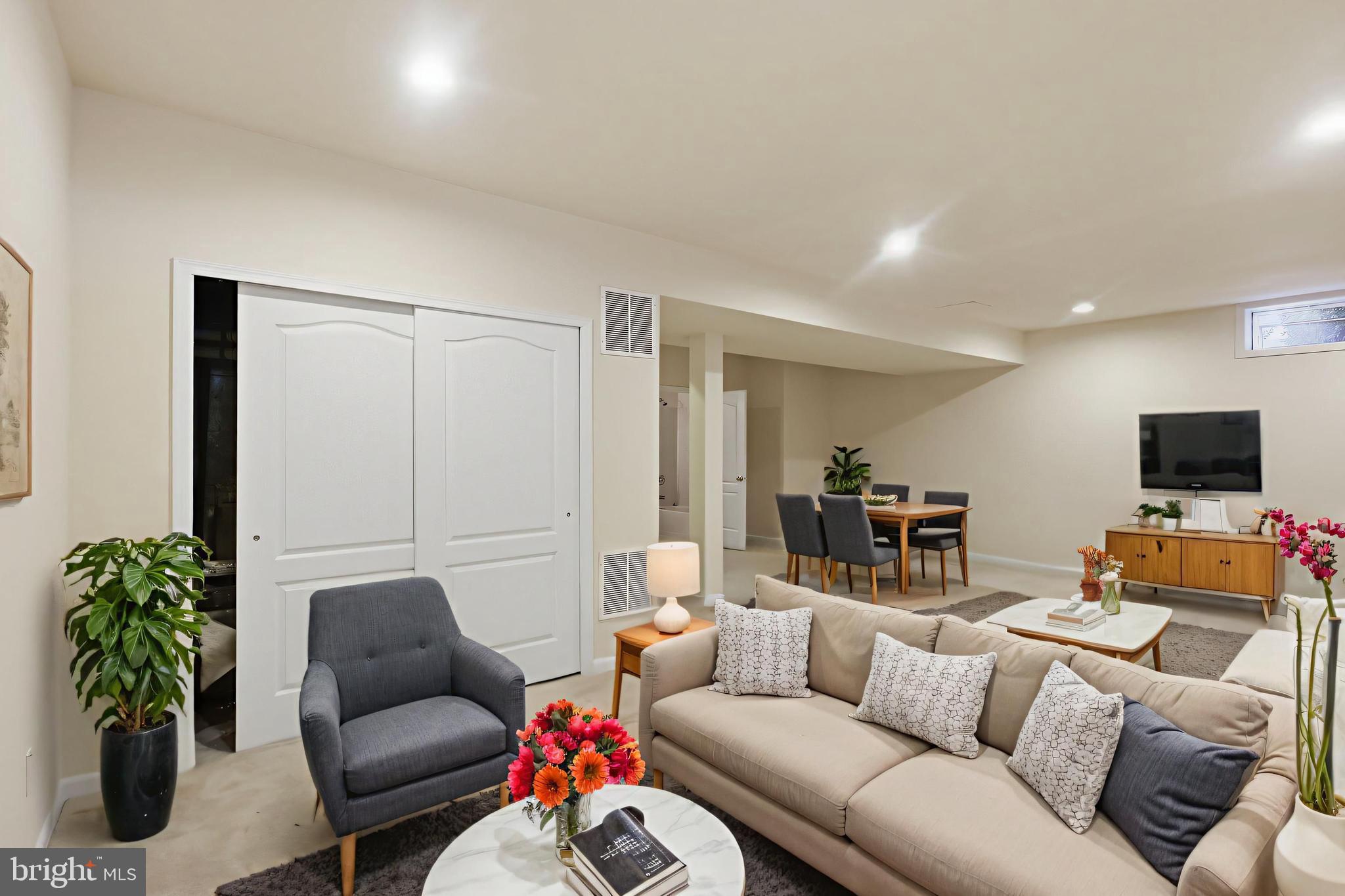 19617 Edgemont Square Ashburn, VA 20147 - Photo 40 of 65 a living room with furniture and a flat screen tv