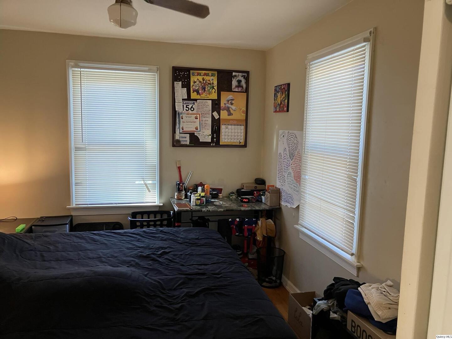 2415 Larch Road Quincy, IL 62301 - Photo 9 of 18 a bedroom with a bed and wooden floor