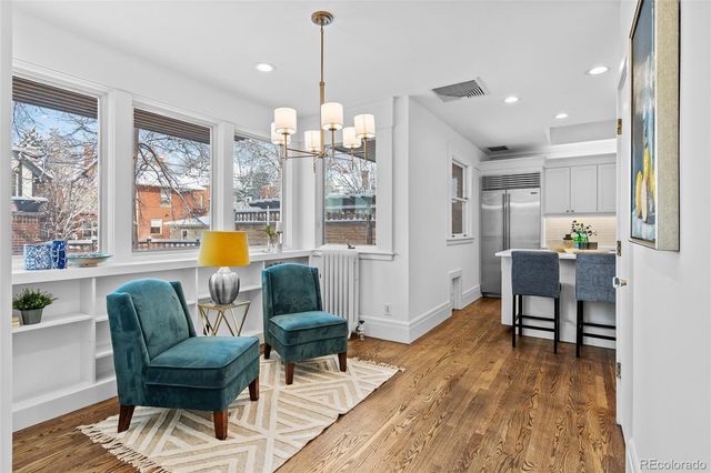 a living room with fireplace furniture and a wooden floor